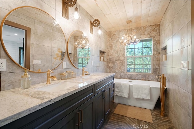 bathroom with tile walls, wood ceiling, a tub to relax in, vanity, and a notable chandelier