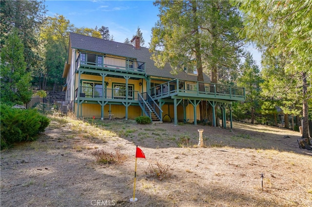 rear view of property featuring a deck