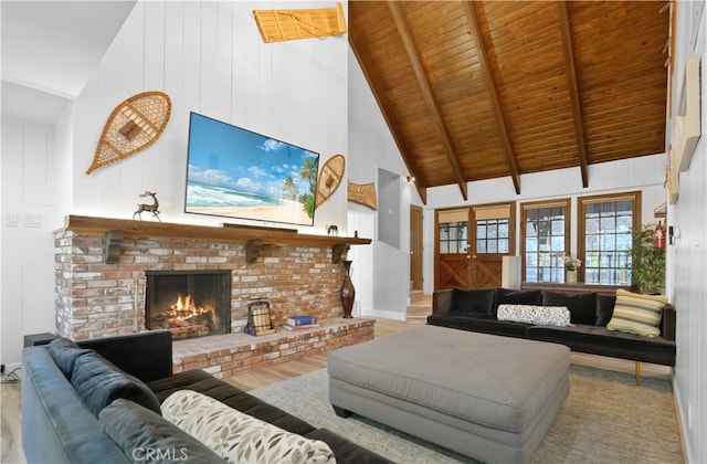 living room featuring beam ceiling, a brick fireplace, high vaulted ceiling, wooden ceiling, and light wood-type flooring