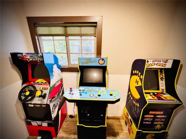 rec room with tile walls and wood-type flooring