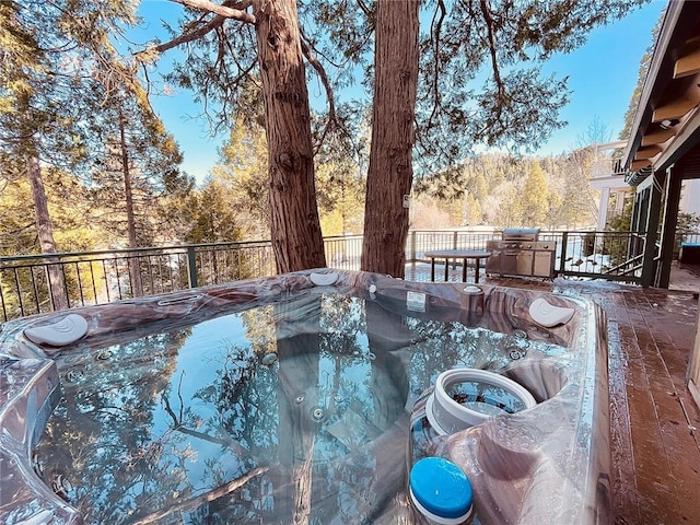 view of pool with a hot tub