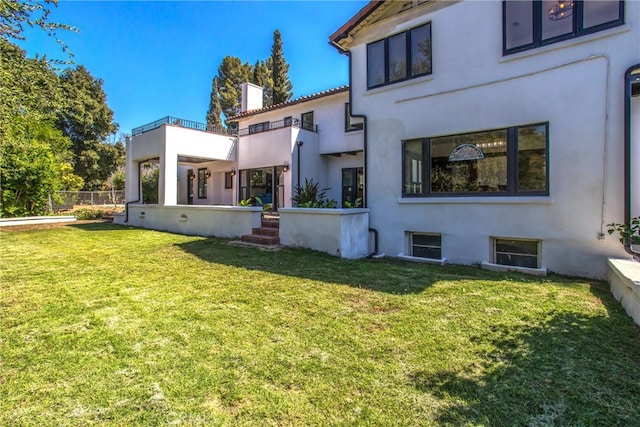 rear view of property with a lawn