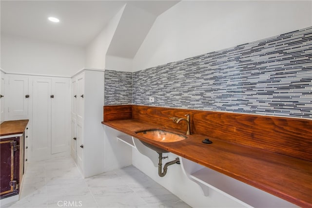 interior space with sink and decorative backsplash