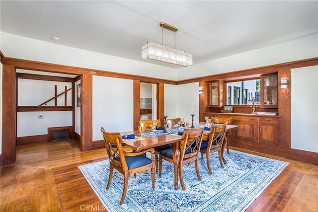 dining space featuring an inviting chandelier, hardwood / wood-style floors, and sink