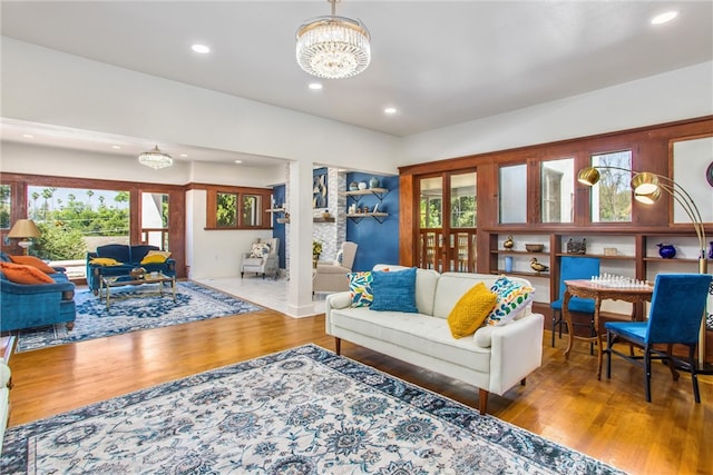 living room with an inviting chandelier and wood-type flooring