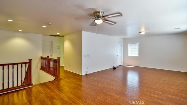 spare room with ceiling fan and dark hardwood / wood-style floors