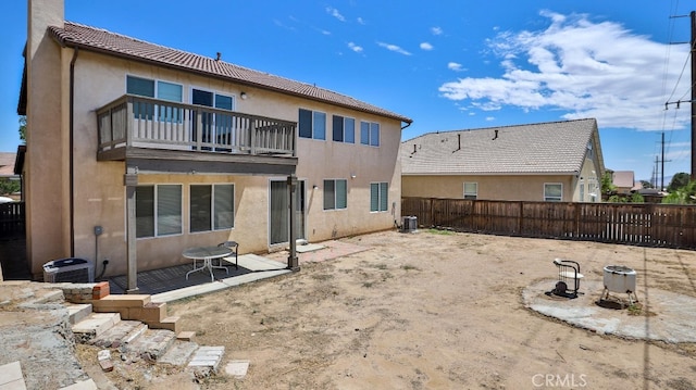 back of property featuring a balcony, a patio, and central AC