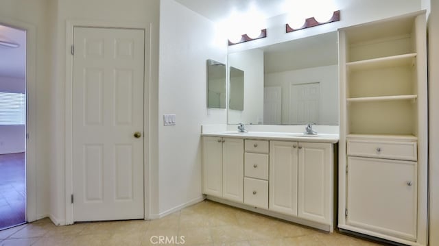 bathroom with tile patterned floors and vanity