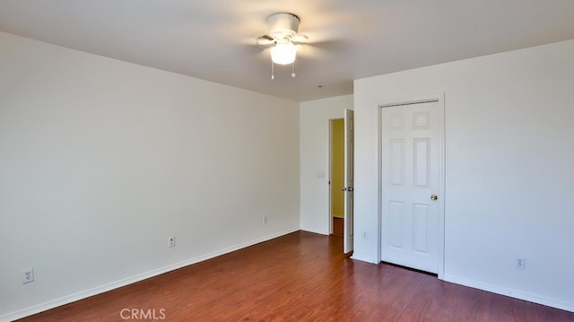 unfurnished bedroom featuring dark hardwood / wood-style flooring and ceiling fan