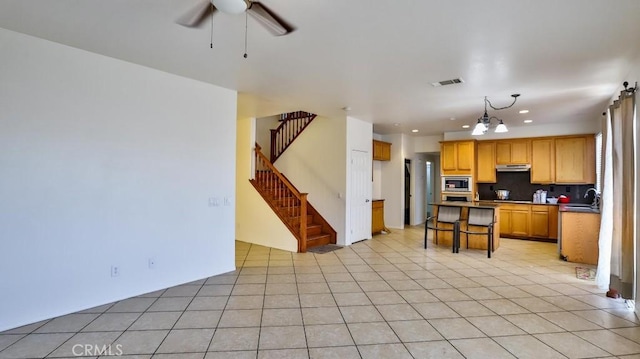 kitchen featuring recessed lighting, a ceiling fan, under cabinet range hood, visible vents, and stainless steel appliances
