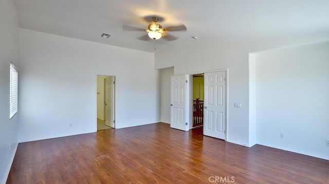 spare room with ceiling fan and dark hardwood / wood-style floors