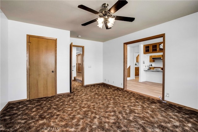 unfurnished bedroom with ceiling fan and carpet