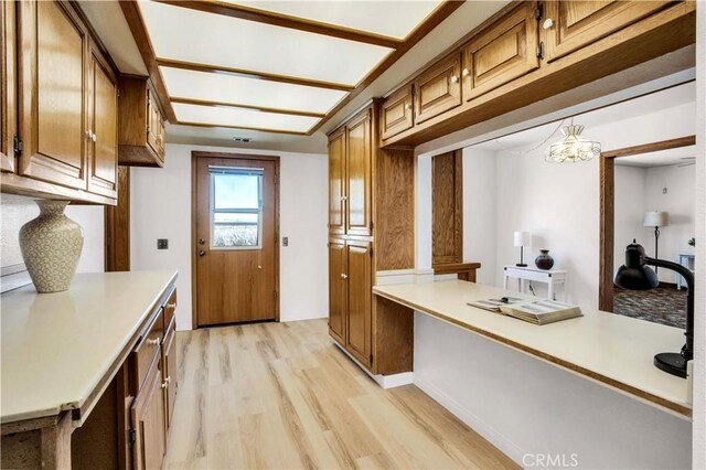 kitchen with light wood-type flooring and built in desk