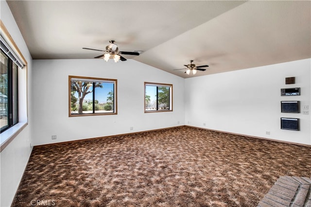 unfurnished room with carpet floors, vaulted ceiling, and ceiling fan