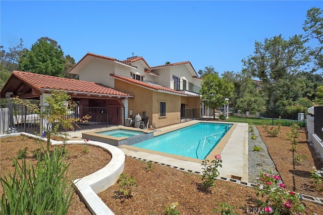 view of pool featuring a patio area and an in ground hot tub