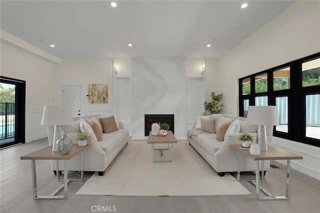 living room with a fireplace and light hardwood / wood-style flooring