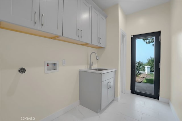 laundry area featuring cabinets, washer hookup, and sink