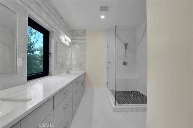 bathroom with vanity and a shower with shower door