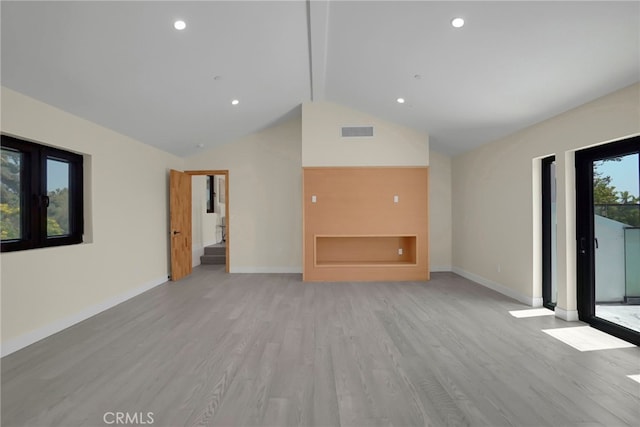 unfurnished living room featuring beam ceiling, light hardwood / wood-style flooring, and high vaulted ceiling