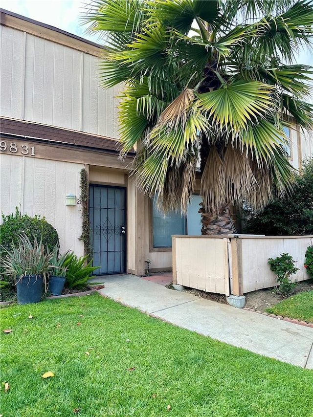 doorway to property with a yard