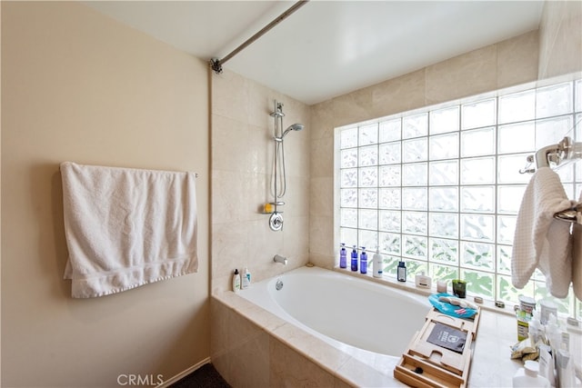 bathroom featuring a wealth of natural light and independent shower and bath