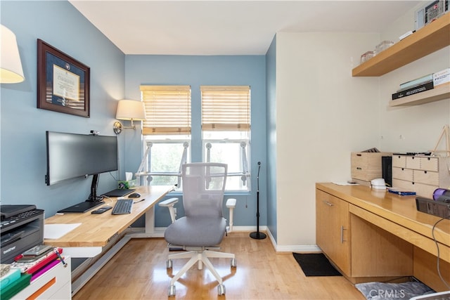 office area with light hardwood / wood-style floors