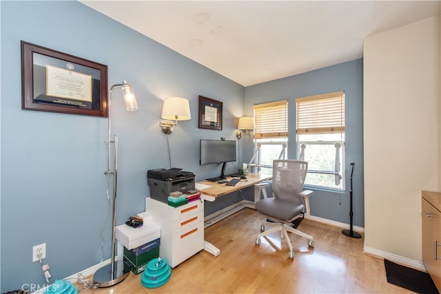 office with light hardwood / wood-style floors