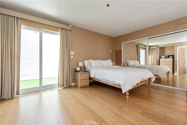 bedroom with light wood-type flooring and a closet