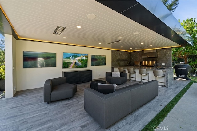 view of patio featuring area for grilling, an outdoor living space, and an outdoor wet bar