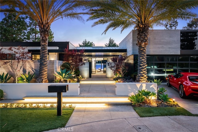 view of outdoor building at dusk