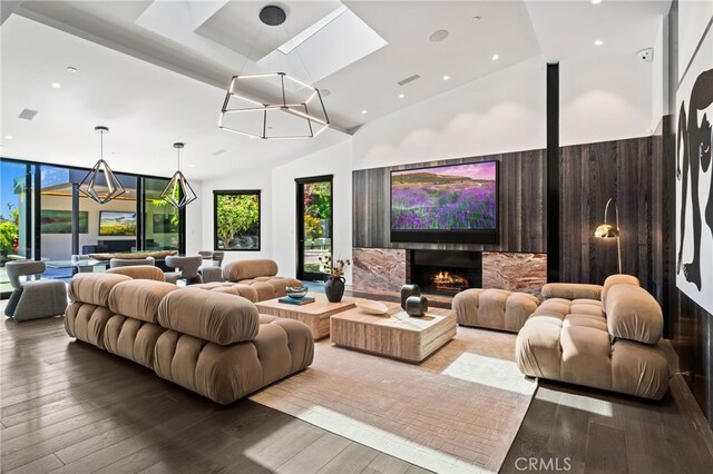 home theater room with wood-type flooring and a notable chandelier