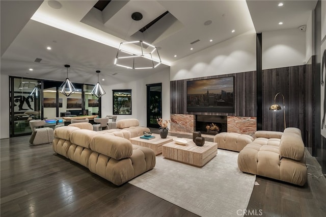 home theater room featuring hardwood / wood-style flooring, a fireplace, and vaulted ceiling