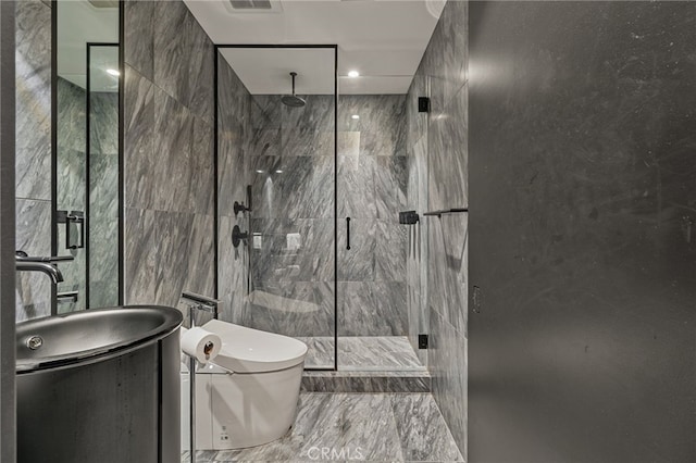 bathroom with vanity, a shower with shower door, tile walls, and toilet