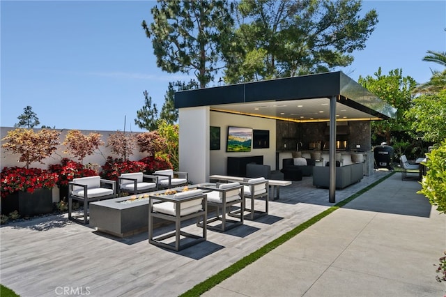 view of patio / terrace featuring grilling area and an outdoor living space with a fire pit