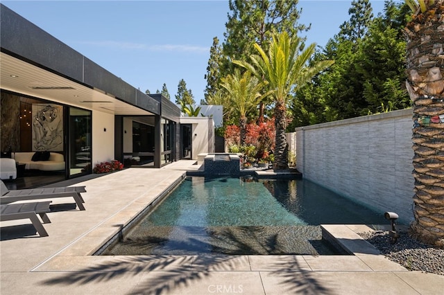 view of swimming pool with a patio area and an in ground hot tub