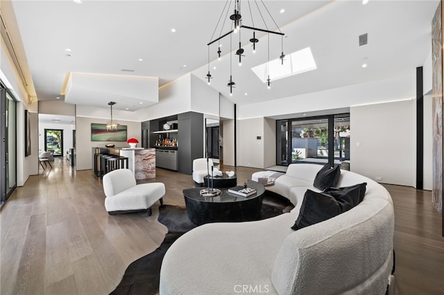 living room with dark hardwood / wood-style flooring and high vaulted ceiling