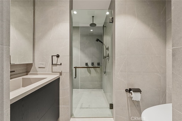 bathroom featuring vanity, a shower with shower door, and toilet