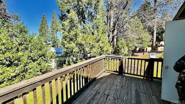 wooden terrace with a lawn