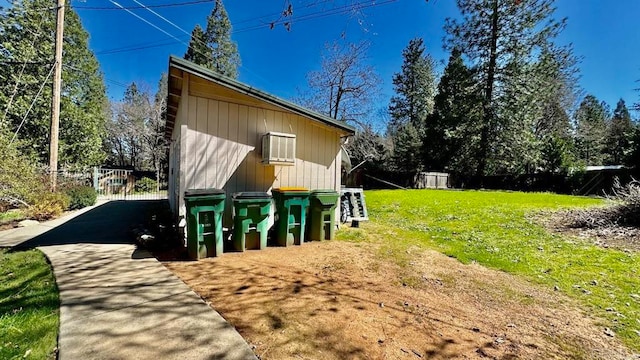 exterior space with an AC wall unit and a lawn