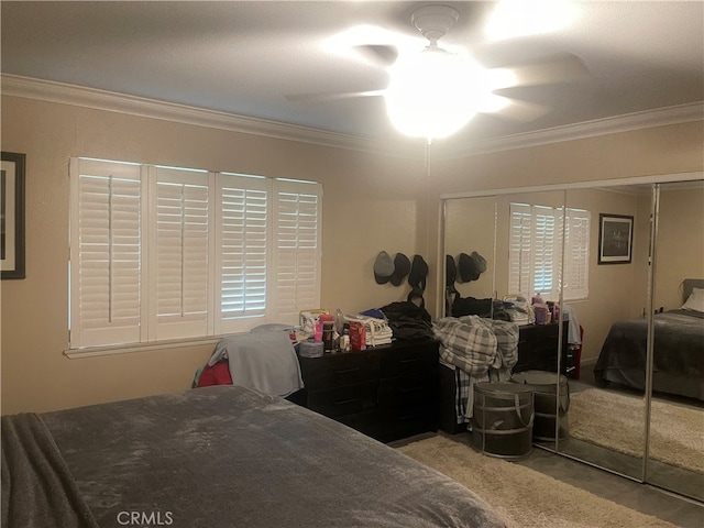 bedroom with ornamental molding, light carpet, a closet, and ceiling fan