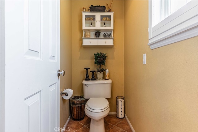 bathroom with toilet and tile patterned floors