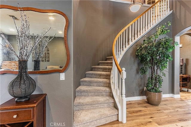 staircase with wood-type flooring