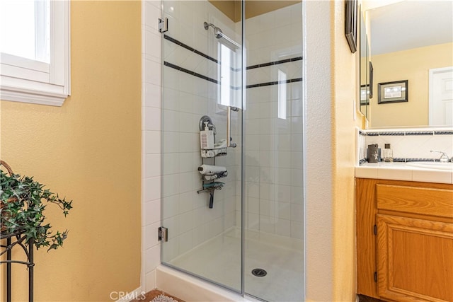 bathroom with vanity and a shower with shower door