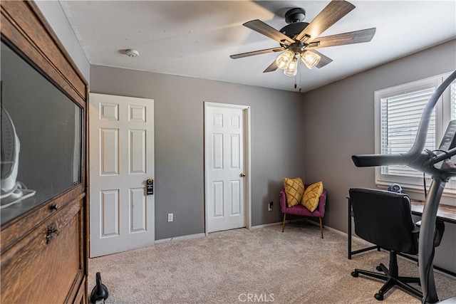 carpeted home office with ceiling fan