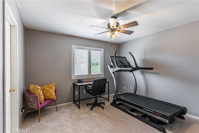 carpeted office featuring ceiling fan