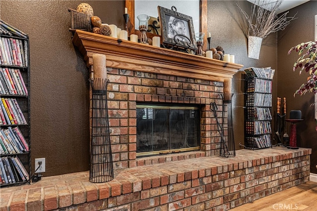 interior details featuring a fireplace and hardwood / wood-style floors