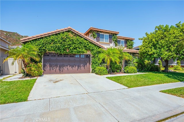 view of front of home with a front lawn and a garage