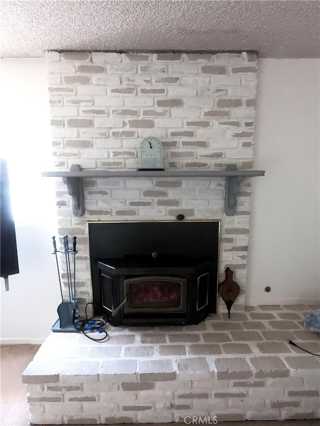 details with a textured ceiling and a wood stove