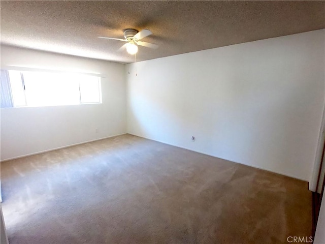 spare room featuring carpet flooring, a textured ceiling, and ceiling fan