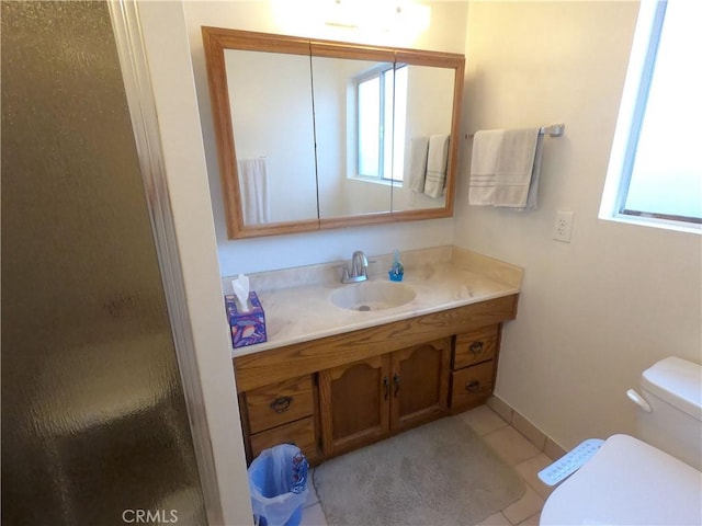 bathroom featuring tile patterned flooring, plenty of natural light, an enclosed shower, and vanity